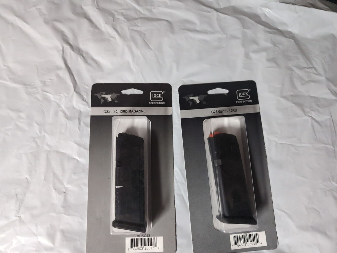 Glock G23 .40 Caliber 13-Round and 10-Round Magazines: A set of two factory Glock magazines for the G23 model. The first is a 13-round magazine chambered in .40 caliber. The second is a G23 Gen5 10-round magazine. Both items are sealed in original retail 