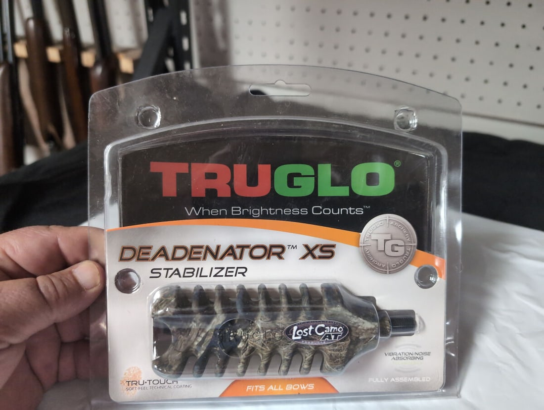 Truglo Deadenator XS Stabilizer Lost Camo AT: A Truglo Deadenator XS stabilizer for archery bows, featuring Lost Camo AT pattern. This unit utilizes rubber molded technology for noise and vibration absorption and includes a Tru-Touch soft-feel te