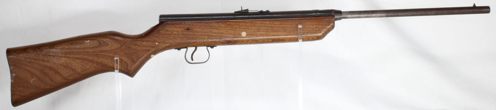 Crosman V-350 Slide Action BB Gun: Crosman Model V-350 slide-action BB gun. Wood stock with blued metal barrel and receiver, pump/slide-action loading. Condition shows typical wear from age and use.
