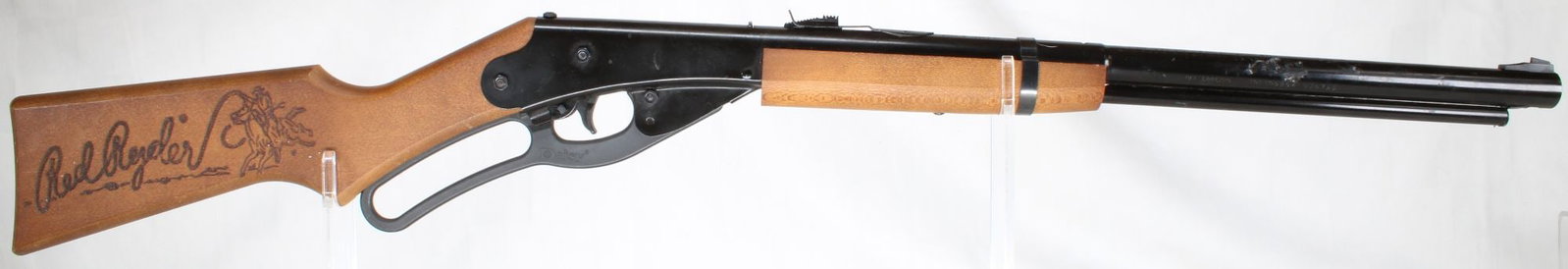 Daisy 1938B Red Ryder BB Gun: Second Daisy Model 1938B Red Ryder BB gun. Wood stock and forearm with blued metal receiver and lever-action loading. Condition shows typical wear from age and use.