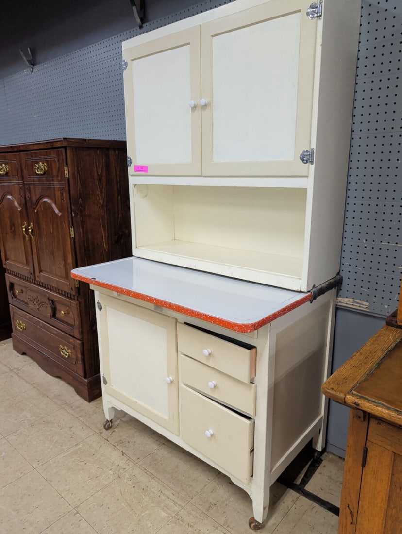 Antique Hoosier-Style Kitchen Cabinet with Porcela: Early 20th century Hoosier-style kitchen cabinet featuring a painted cream finish and porcelain-enamel work surface with distinctive red speckled border. Upper section features a pair of paneled