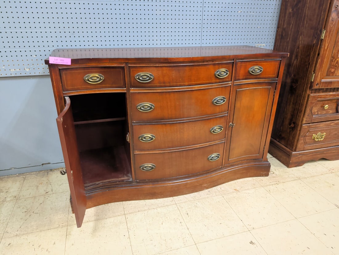 Bowfront Sideboard with Three Central Drawers and: A wooden sideboard featuring a bowfront design. The unit includes three central stacked drawers and two side cabinets, each with a single drawer above a door. The top drawer is lined with green felt.