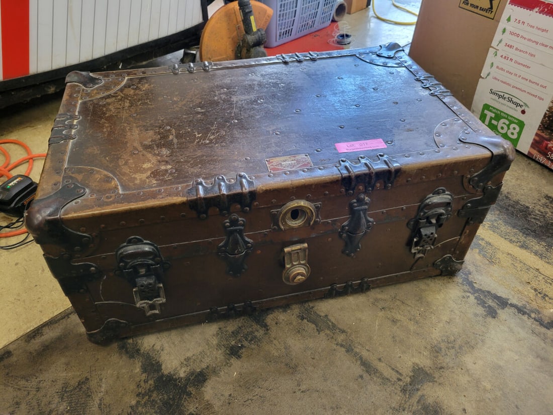 Headley & Farmer Co. Fibre-Covered Trunk: A fibre-covered and fibre-lined storage trunk manufactured by Headley & Farmer Co. of New York. The exterior features metal corner reinforcements, riveted construction, and a central locking