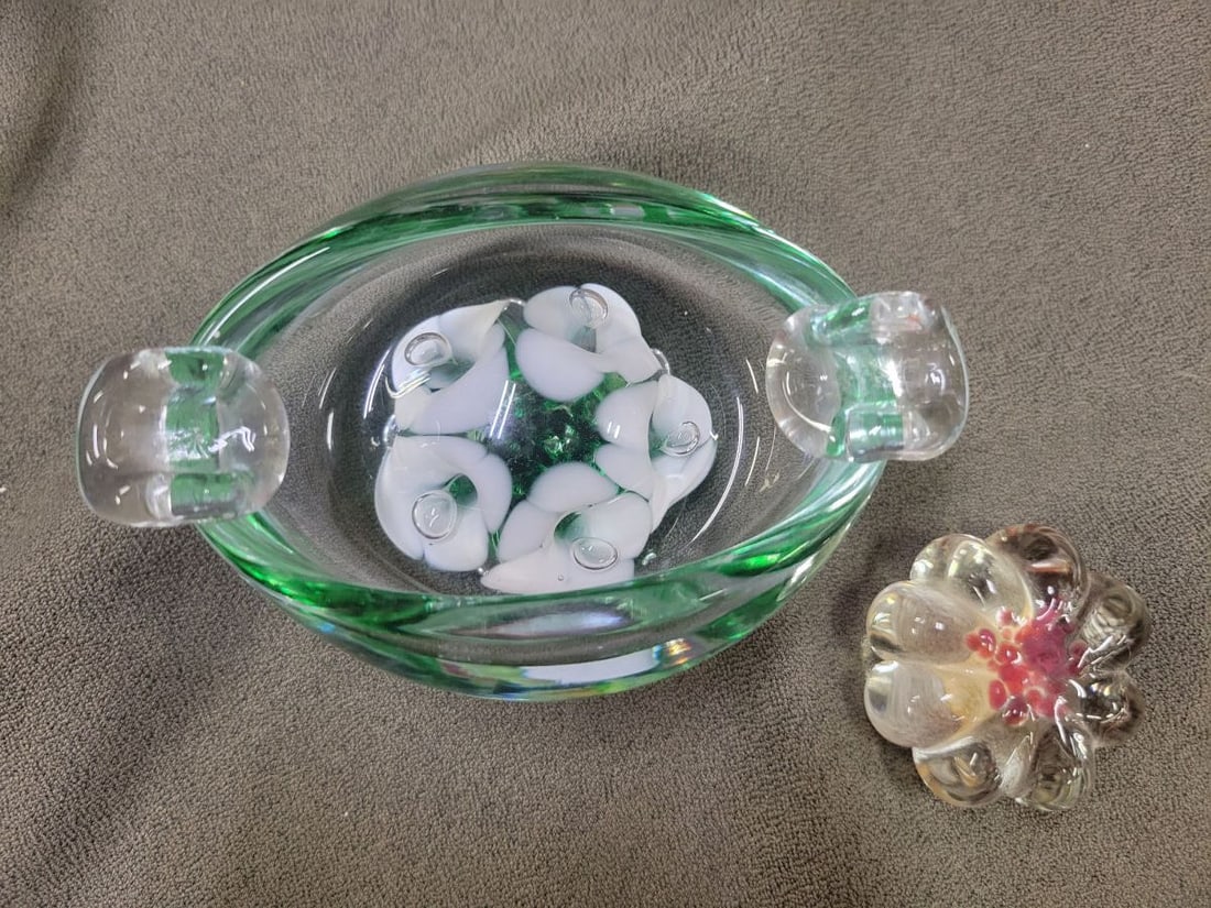 St. Clair Art Glass Bowl with Floral Paperweight: A clear glass bowl featuring green and white internal inclusions, marked St. Clair on the base. Accompanied by a separate, multi-colored floral glass paperweight.