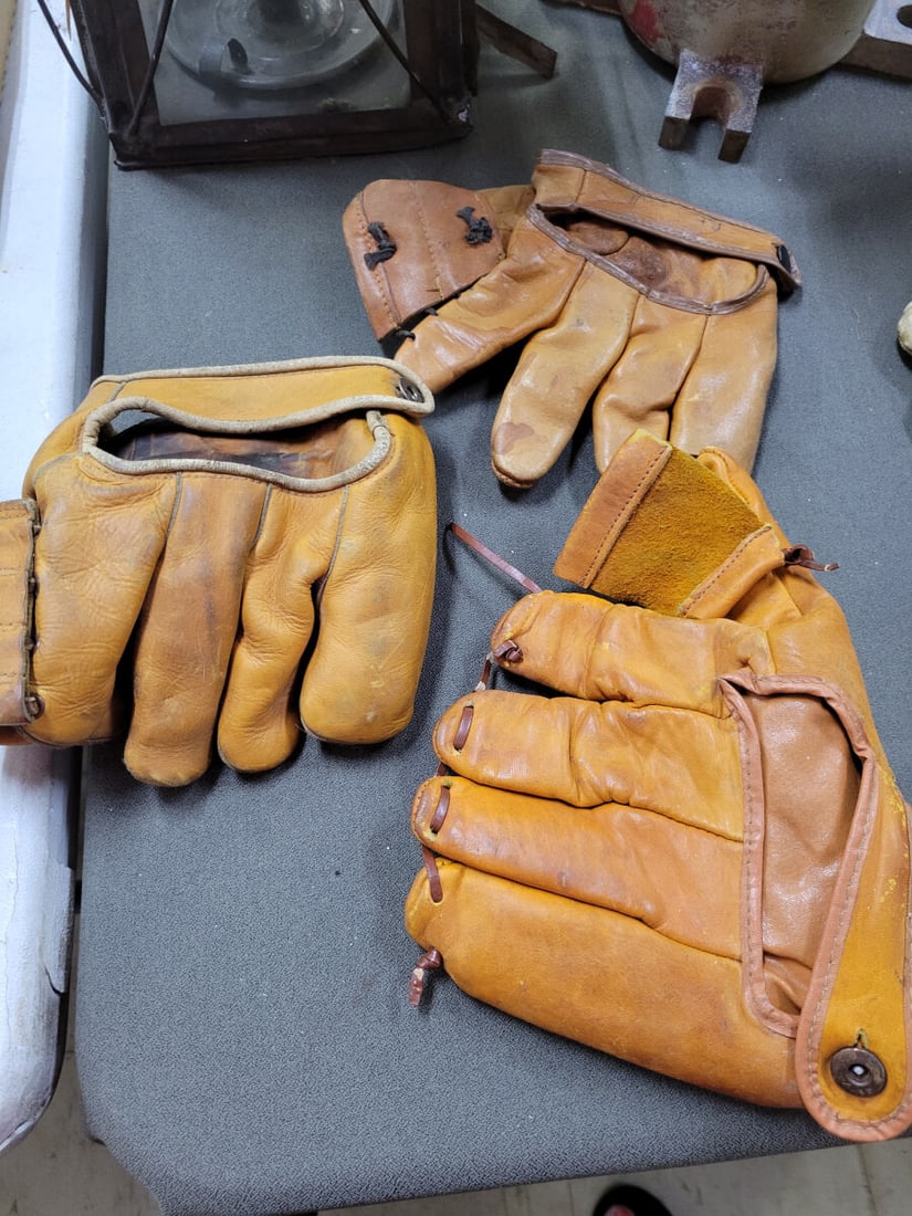 Collection of Three Leather Baseball Gloves Includ: A lot of three leather baseball gloves featuring various manufacturer markings. Included is a Nokona Professional Model glove made of genuine cowhide, a Midco League Model glove with a hand-formed poc