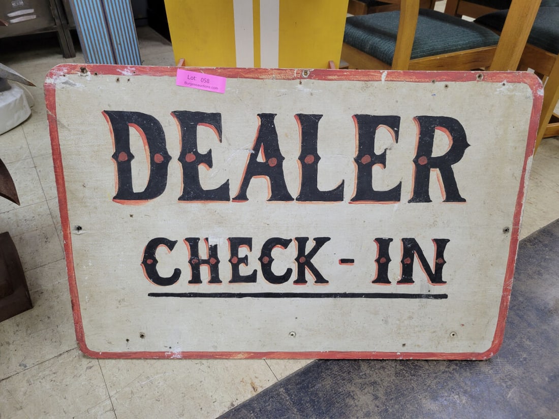 Double-Sided Dealer Check-In Sign: A double-sided rectangular sign featuring the text 'DEALER CHECK-IN'. One side displays black lettering with orange accents and a red border, while the reverse side features black lettering wi