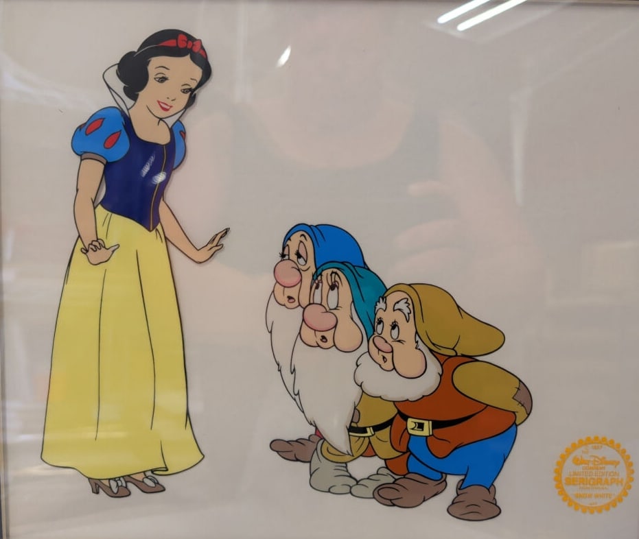 Walt Disney Limited Edition Snow White Serigraph C: A framed limited edition serigraph cel featuring Snow White and three dwarfs. The piece includes a gold-colored seal on the lower right corner and is accompanied by a Letter of Authenticity and Insura