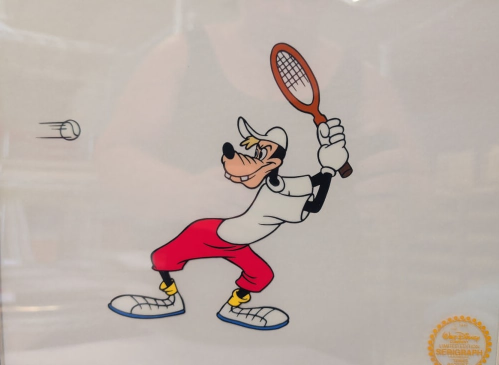 Walt Disney Limited Edition Serigraph Goofy Tennis: A framed limited edition serigraph featuring the Disney character Goofy playing tennis. The artwork includes a gold-colored seal on the lower right corner. The piece is presented in a metallic frame w