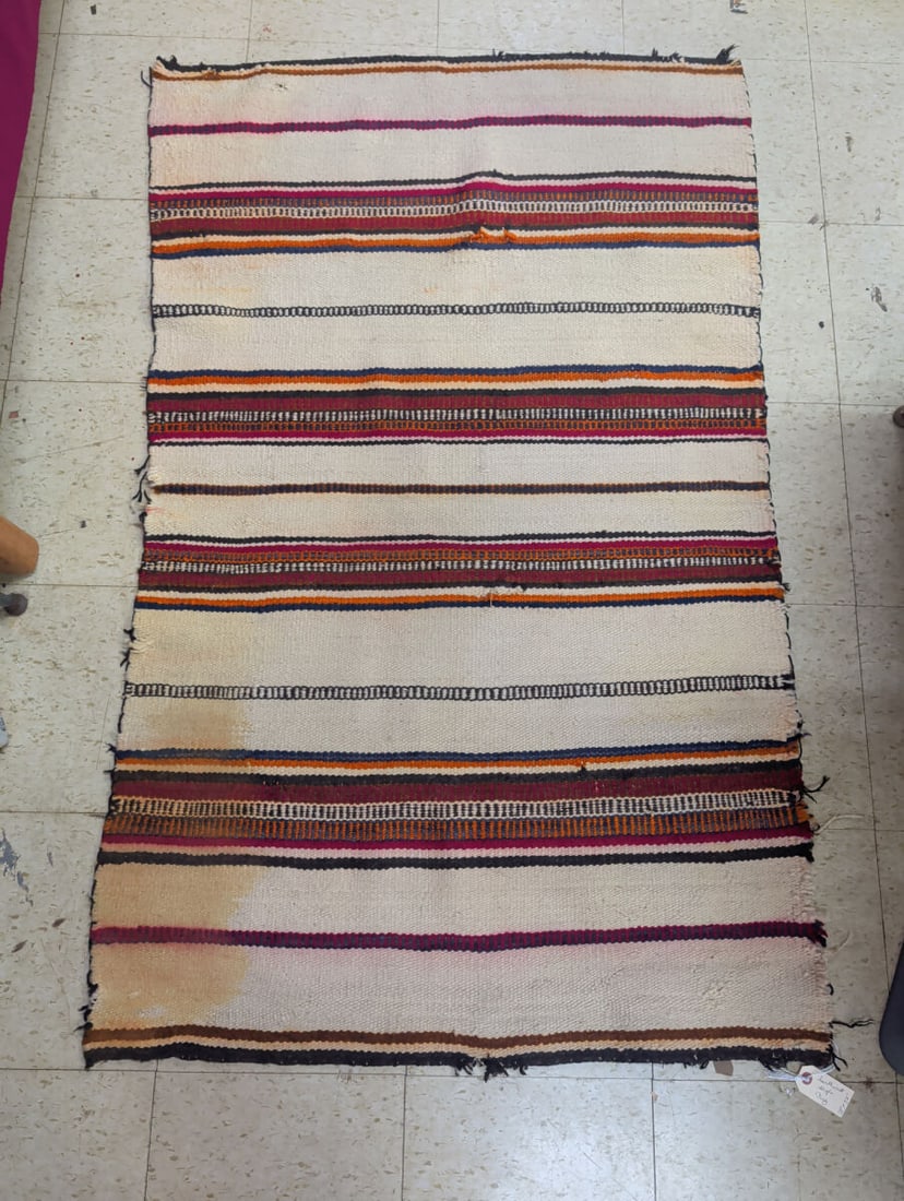 Southwest Style Woven Rug 35 x 57 Inches: A woven rug featuring a Southwest-inspired striped pattern in a palette of cream, red, orange, blue, and black. The rug measures approximately 35 inches by 57 inches. The piece exhibits areas of disco