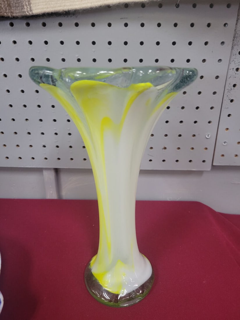 Hand-Blown Art Glass Vase with Yellow and White Sw: A hand-blown art glass vase featuring a flared, ruffled rim and a tapered body. The piece displays a decorative swirl pattern of opaque white and yellow glass encased in clear glass. The base features