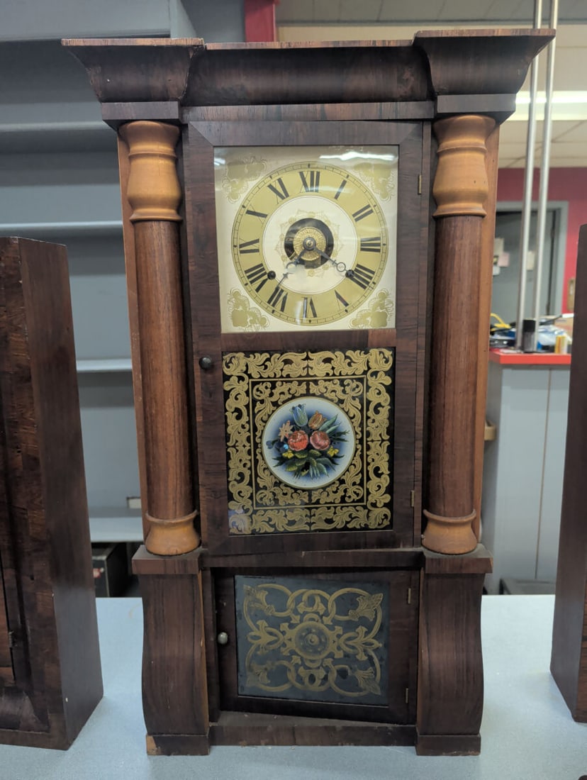 Seth Thomas Eight-Day Weight-Driven Column Shelf C: Late 19th-century Seth Thomas eight-day weight-driven shelf clock housed in an architectural walnut veneered case with turned columns, molded crest, and double glazed doors. The upper door features an