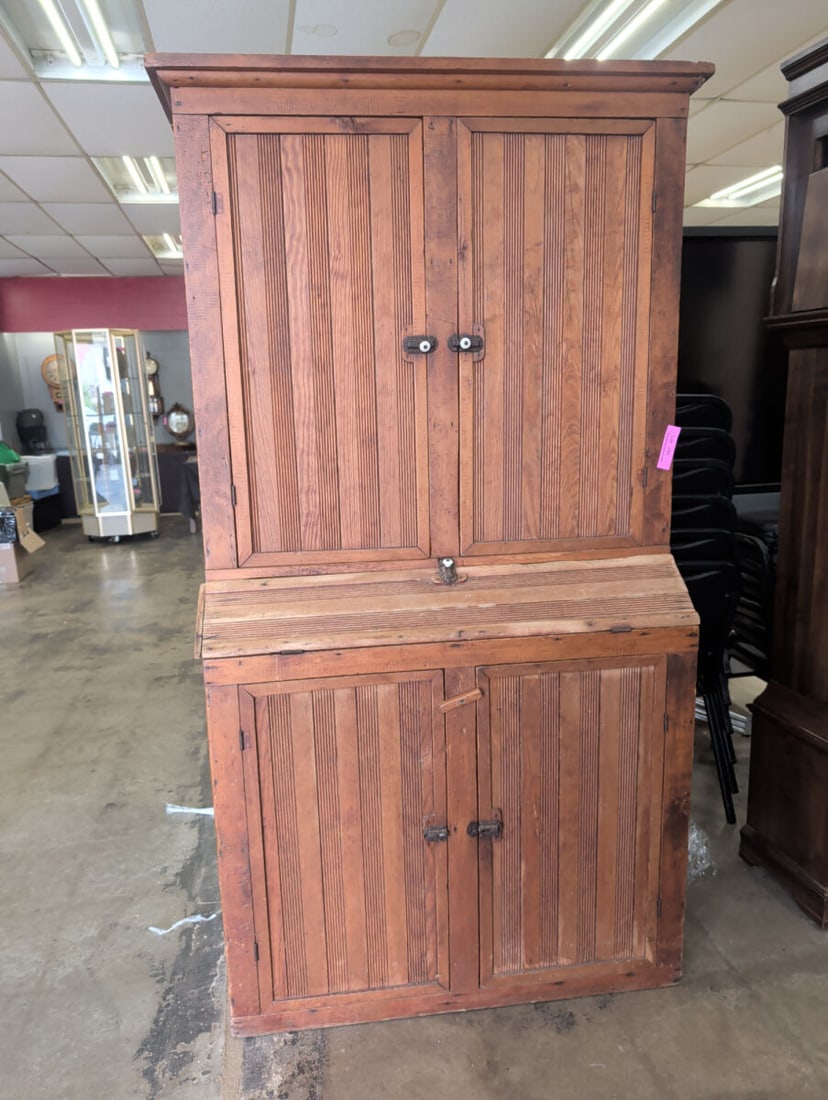 19th C. Primitive Pine Step-Back Cupboard: Antique American primitive step-back cupboard constructed of pine with a warm, aged surface. Features a projecting molded cornice above a two-door upper cabinet and a deeper two-door base. All four do