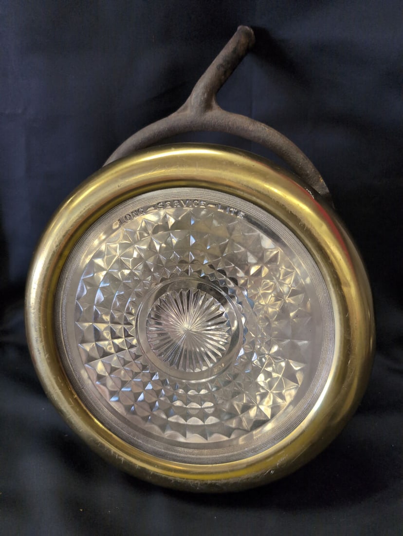 Gray & Davis Brass Headlight Made for Cadillac with Long Service Lite Lens: Brass automotive headlight manufactured by Gray & Davis for Cadillac. Features a faceted glass lens marked 'Long Service Lite' and a top mounting bracket. The housing displays stamped maker and brand