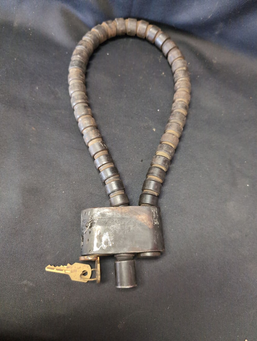 Johnson Universal Spare Tire Lock with Keys and Segmented Armor Cable: Johnson Universal spare tire lock manufactured by Johnson Auto Lock Co. of St. Louis, Missouri. Features a heavy-duty segmented armor cable design, built-in locking mechanism, and included matching ke