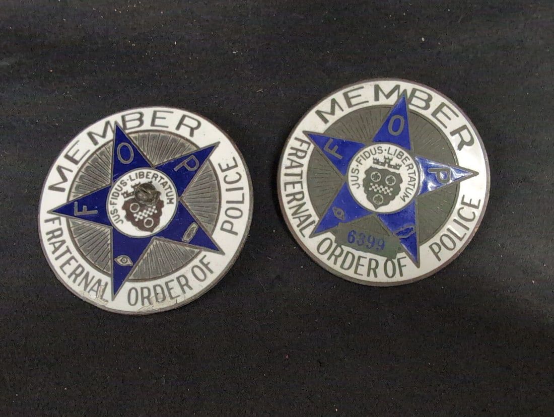 Fraternal Order of Police FOP Member Lapel Pins, Set of 2: Set of two circular Fraternal Order of Police (FOP) member lapel pins featuring enameled blue and white details, a central five-pointed star, and lettering reading MEMBER FRATERNAL ORDER OF POLICE. On
