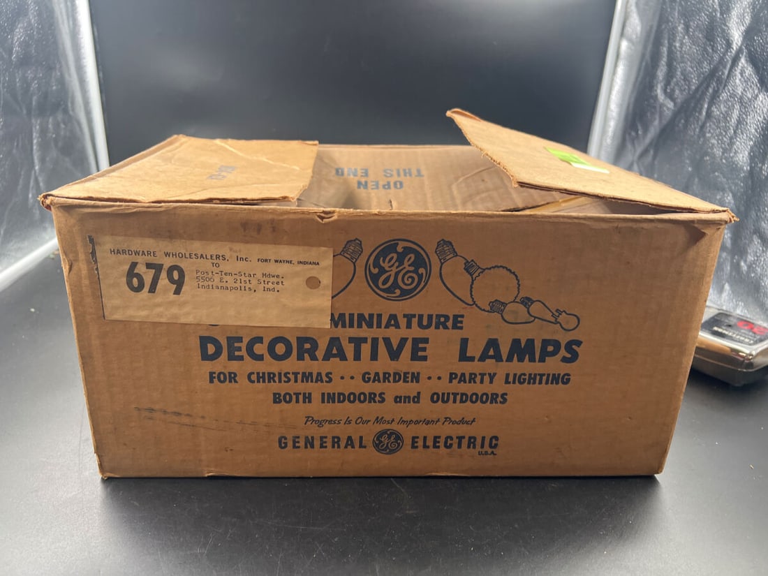 General Electric Miniature Decorative Lamps Bulk Case with C6 Indoor Series Light Bulbs: Bulk master carton of General Electric miniature decorative lamps, specifically C6 Indoor Series Christmas and decorative light bulbs. The master brown cardboard shipping box is marked for Hardware Wh