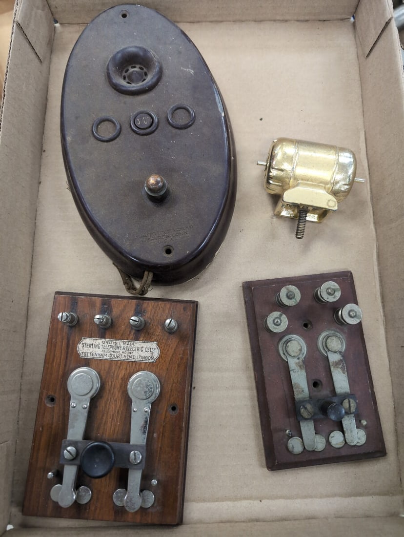 Collection of Telecommunication Parts Including Sterling and Connecticut Telephone: A collection of telecommunication and electrical hardware components featuring two wood-mounted panel boards by Sterling Telephone & Electric Co. Ltd. (London, England), an oval bakelite housing unit 