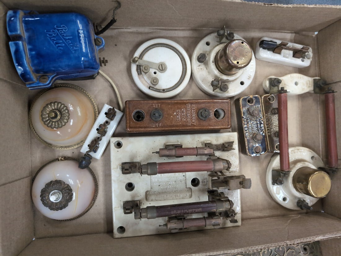 Assorted Electrical and Radio Components Including WU Telco Protector and Packard Bell: Collection of assorted electrical and radio hardware components including a WU Telco Protector 22A manufactured by Fahnestock Elec. Co., a blue ceramic Packard Bell door bell, radio lightning arrester