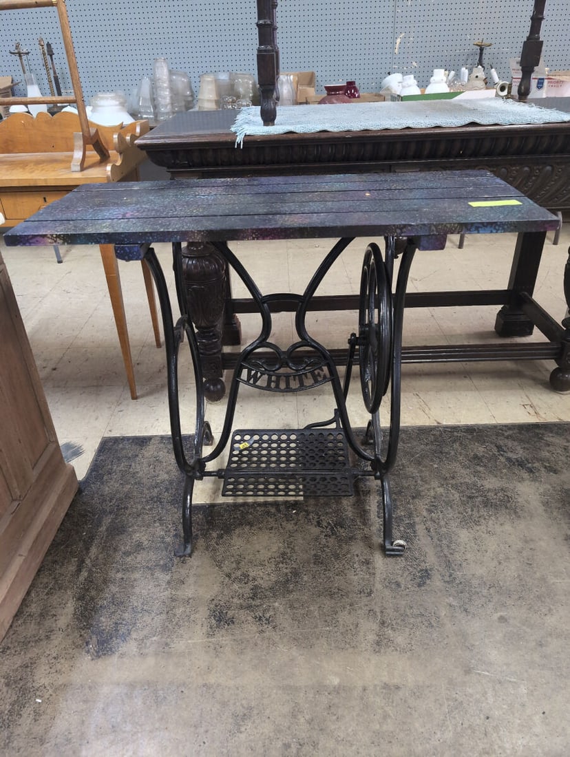 White Cast Iron Sewing Machine Base Table with Custom Painted Wooden Top: Repurposed sewing machine base featuring a black cast iron treadle stand marked WHITE with integrated foot pedal and side wheel. The top is constructed from slatted wood and finished with a custom dec
