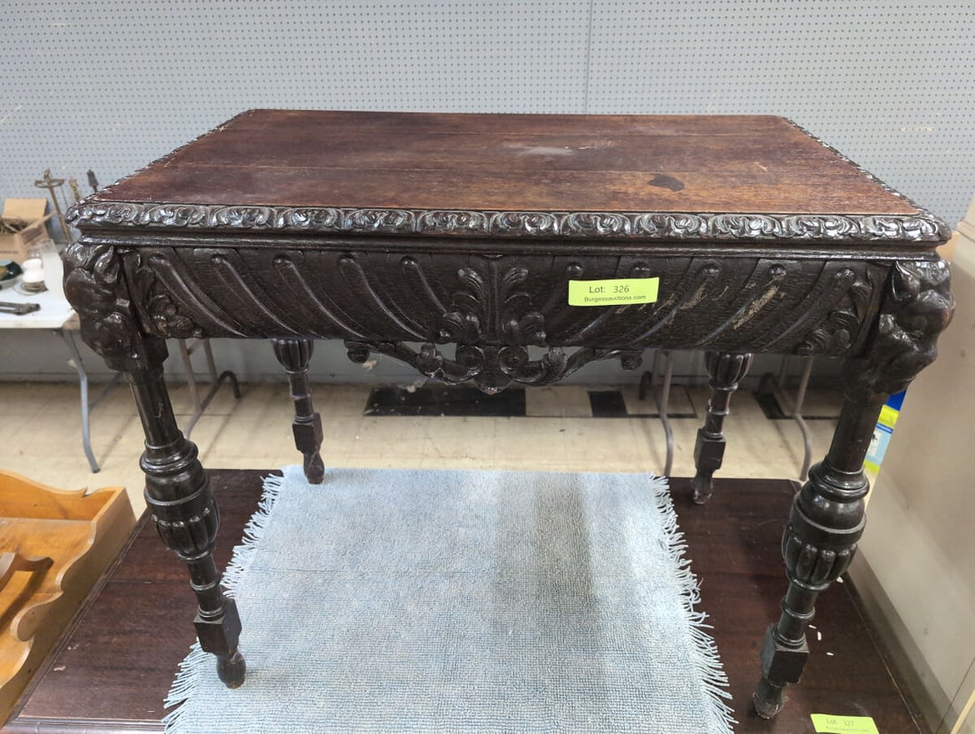 Antique Renaissance Revival Carved Hall Table with Lion Masks: Impressive Renaissance Revival console or hall table featuring a deeply carved apron with radiating foliate and shell-like decoration, scrolling center carving, and bold figural mask terminals at the