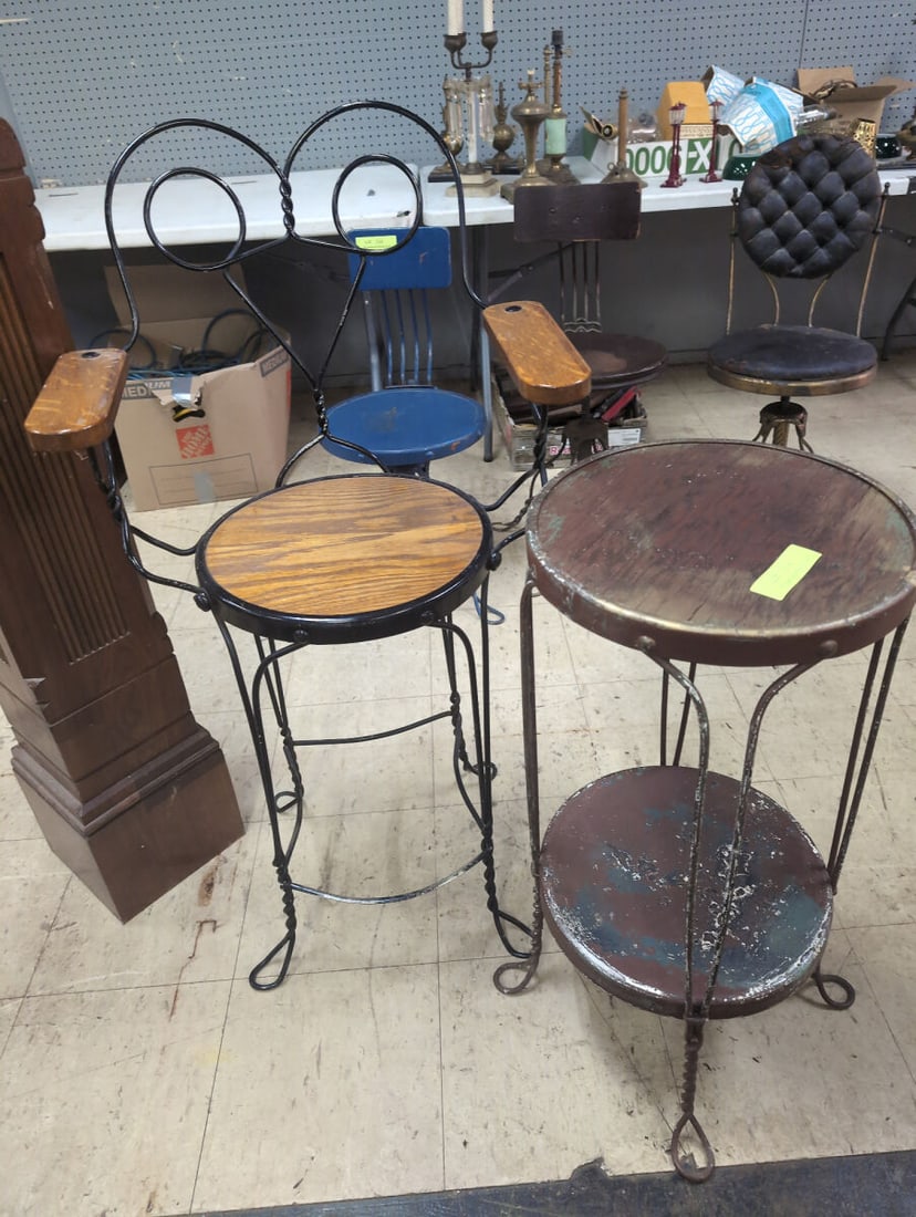 Metal and Wood Bar Stool and Two-Tier Table Set: This listing is for a set containing a metal and wood bar stool with armrests and a matching two-tier round metal and wood table. Both pieces feature twisted metal legs and wooden surfaces with visibl