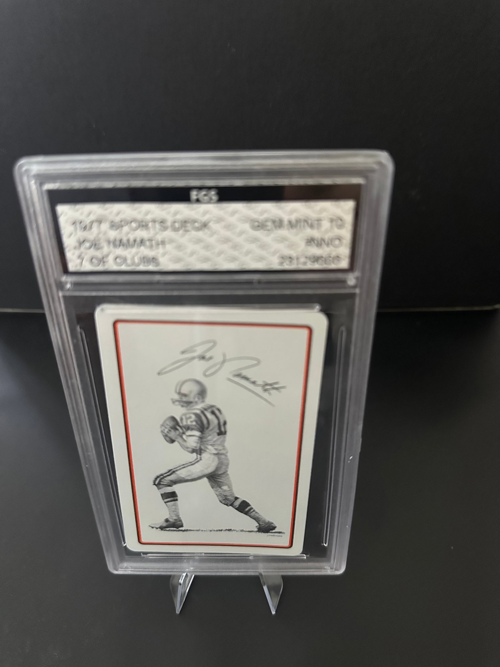 Signed Football Card of Joe Namath: Gem Mint 10 7 of Clubs signed football card featuring legendary quarterback Joe Namath. The card is encapsulated in a protective case, indicating its good condition, with an emphasis on preserving the