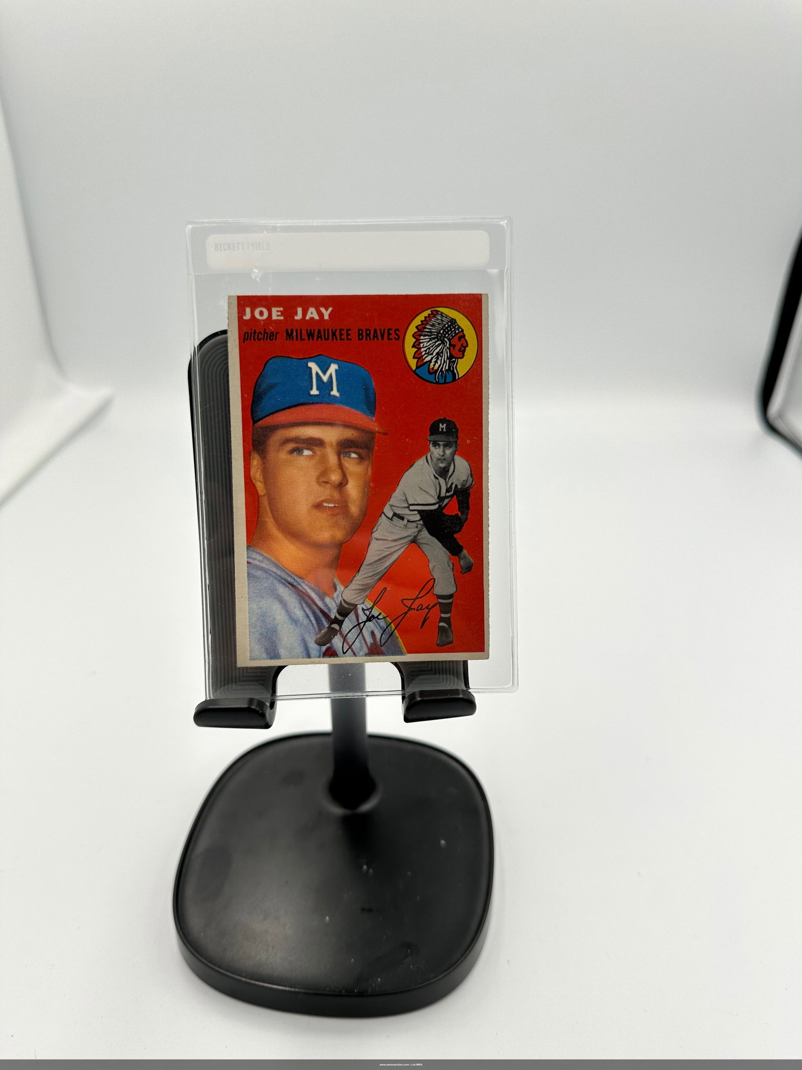 1954 Joe Jay Milwaukee Braves Baseball Card: Vintage 1954 Joe Jay baseball card, featuring the Milwaukee Braves pitcher. The card showcases Joe Jay in his team cap and has a distinctive red background, typical of cards from this era. It is a par