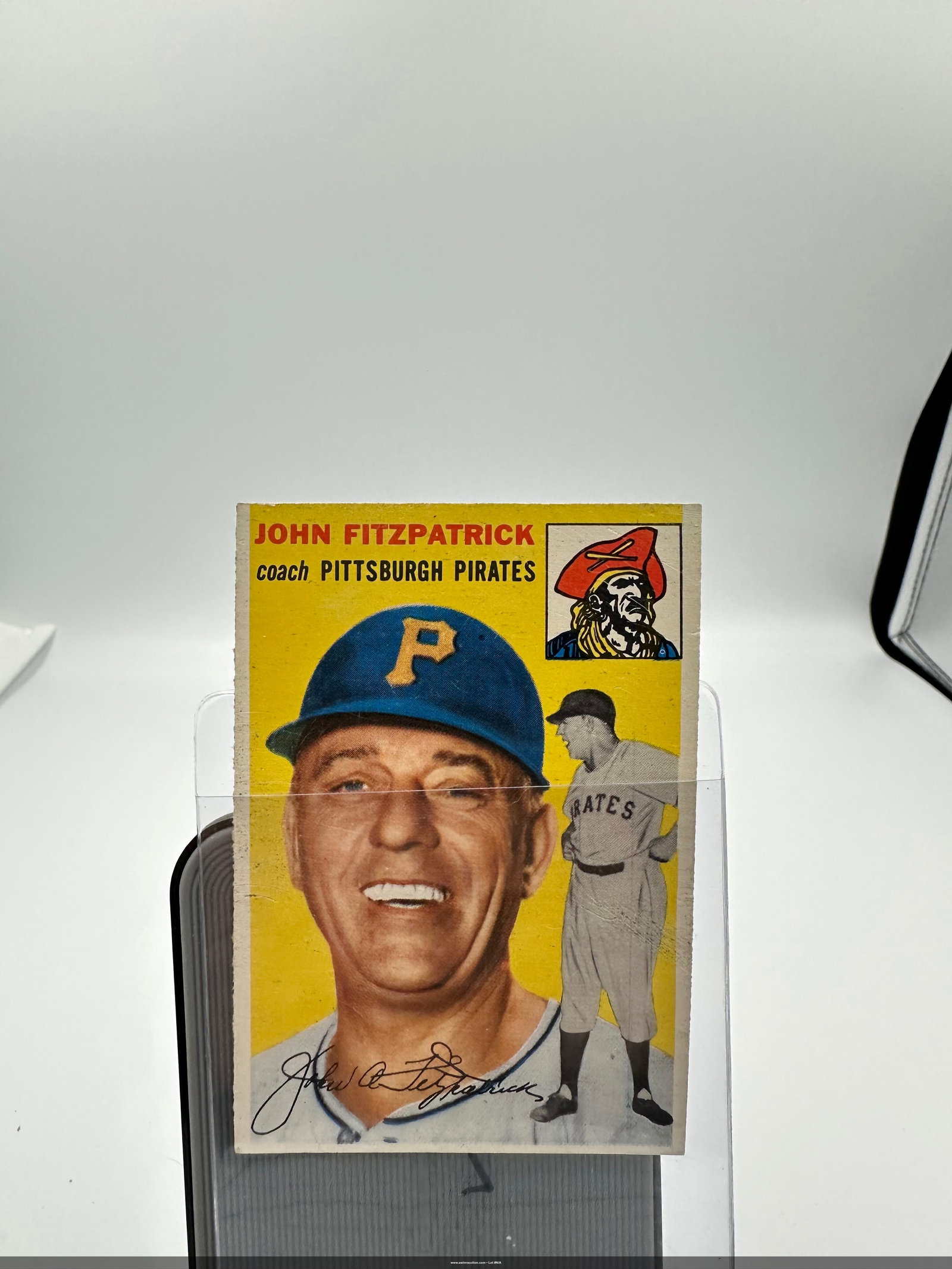 1954 John Fitzpatrick Pittsburgh Pirates Baseball Card: a 1954 baseball card featuring John Fitzpatrick, the coach of the Pittsburgh Pirates. The card showcases a colorful portrait of Fitzpatrick along with imagery representing the Pirates. Notably, it has