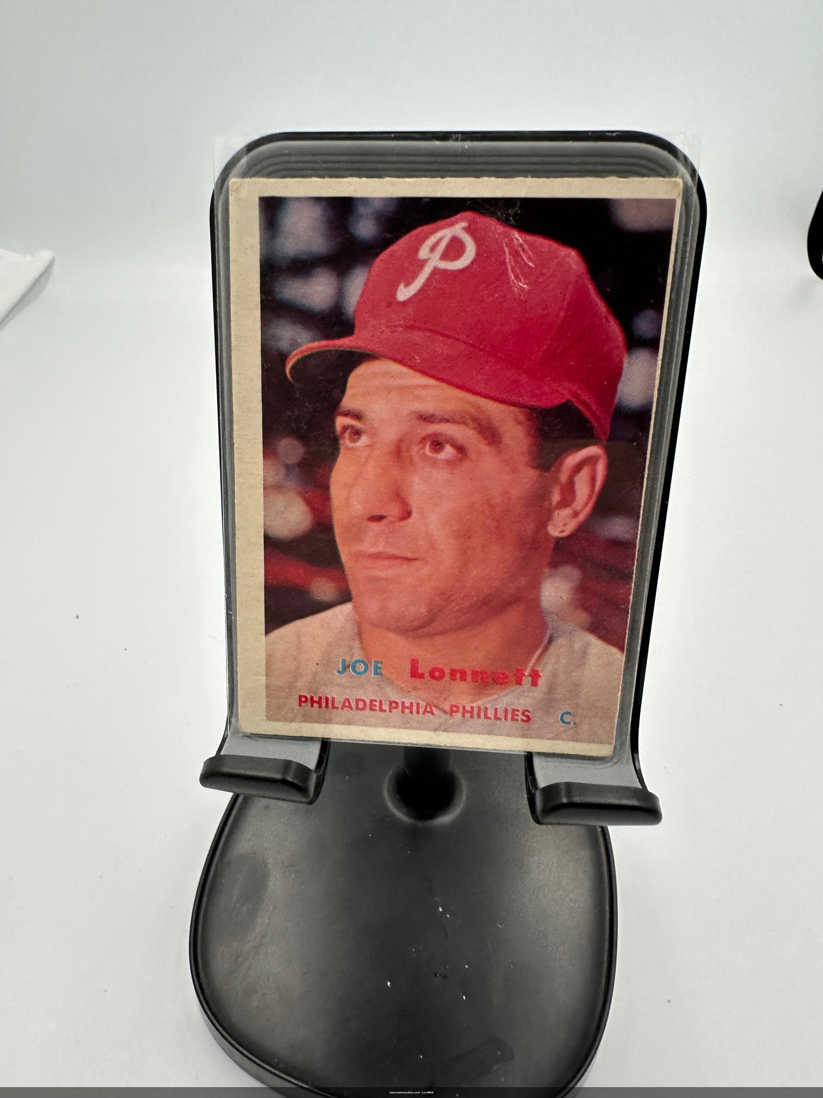 Joe Lonnett 1957 Philadelphia Phillies Baseball Card: Joe Lonnett from the 1957 Topps series. Lonnett played as a catcher for the Philadelphia Phillies, and the card is notable for its classic design and vibrant colors, showcasing his red Phillies cap. a