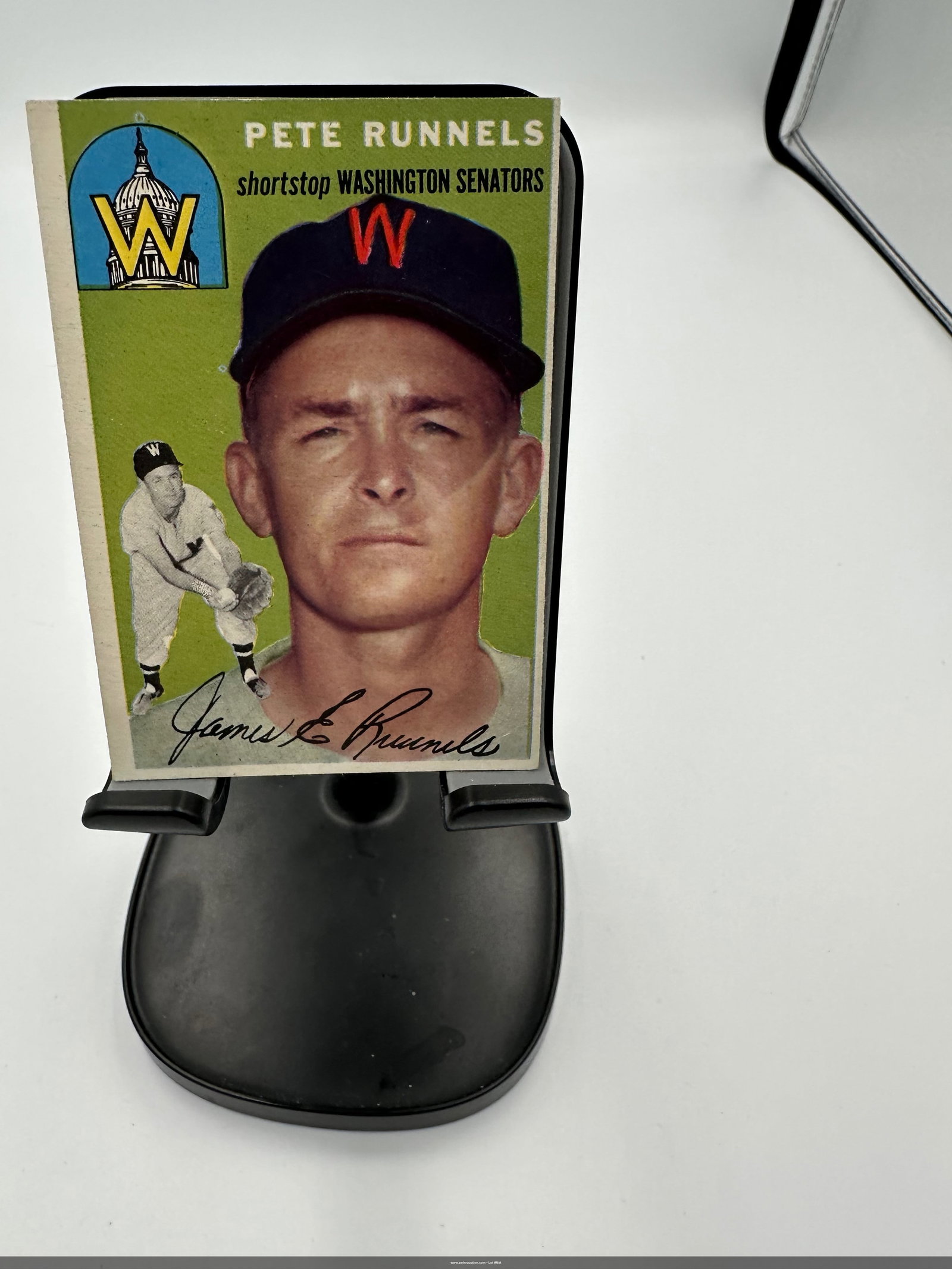 1954 Pete Runnels Washington Senators Baseball Card: a vintage 1954 baseball card featuring Pete Runnels, who played shortstop for the Washington Senators. The card showcases a vibrant green background with a photo of Runnels, and includes important det