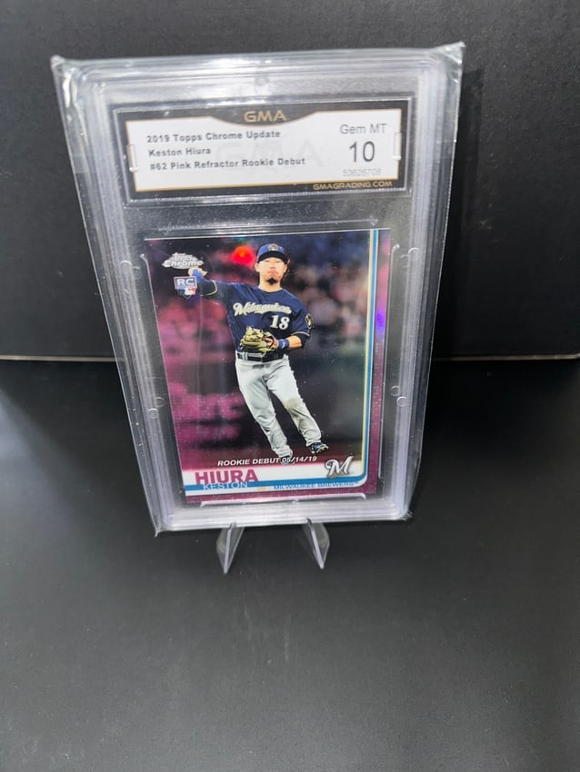 2019 Topps Chrome Update Keston Hiura Pink Refractor RC #162: Graded 2019 Topps Chrome Update Keston Hiura Pink Refractor Rookie Card, graded Gem Mint 10. Featuring Hiura, a player for the Milwaukee Brewers, this card highlights his rookie debut with the number 