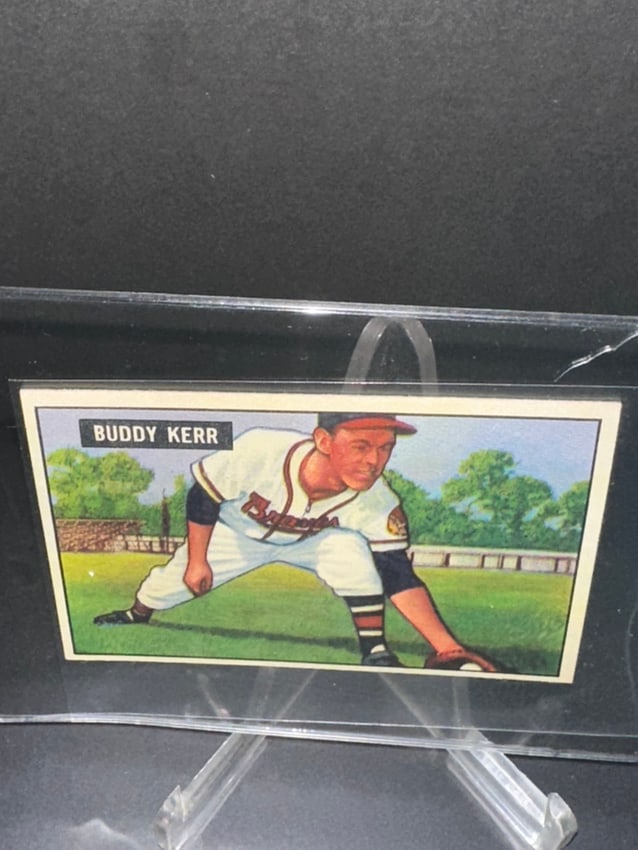 Buddy Kerr Vintage Baseball Card: a vintage baseball card featuring Buddy Kerr, a player for the New York Giants. The card showcases a colorful illustration of Kerr in action, indicative of the era's style, likely produced in the mid-