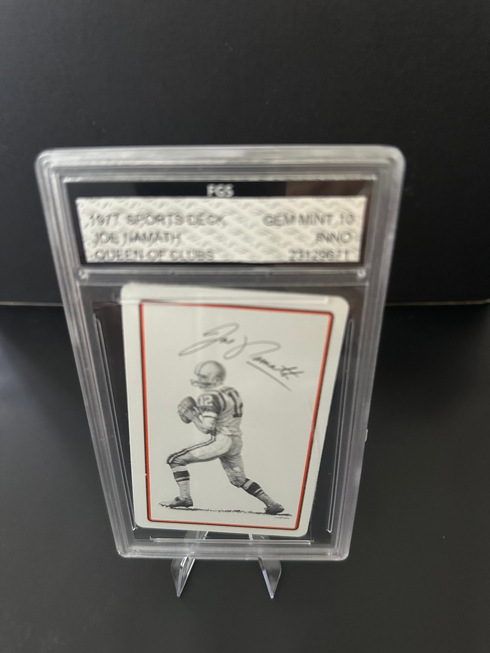 Signed Football Card of Joe Namath Grade 10: 1977 signed football card featuring legendary quarterback Joe Namath Queen of Clubs. The card is encapsulated in a protective case, indicating its good condition, with an emphasis on preserving the si
