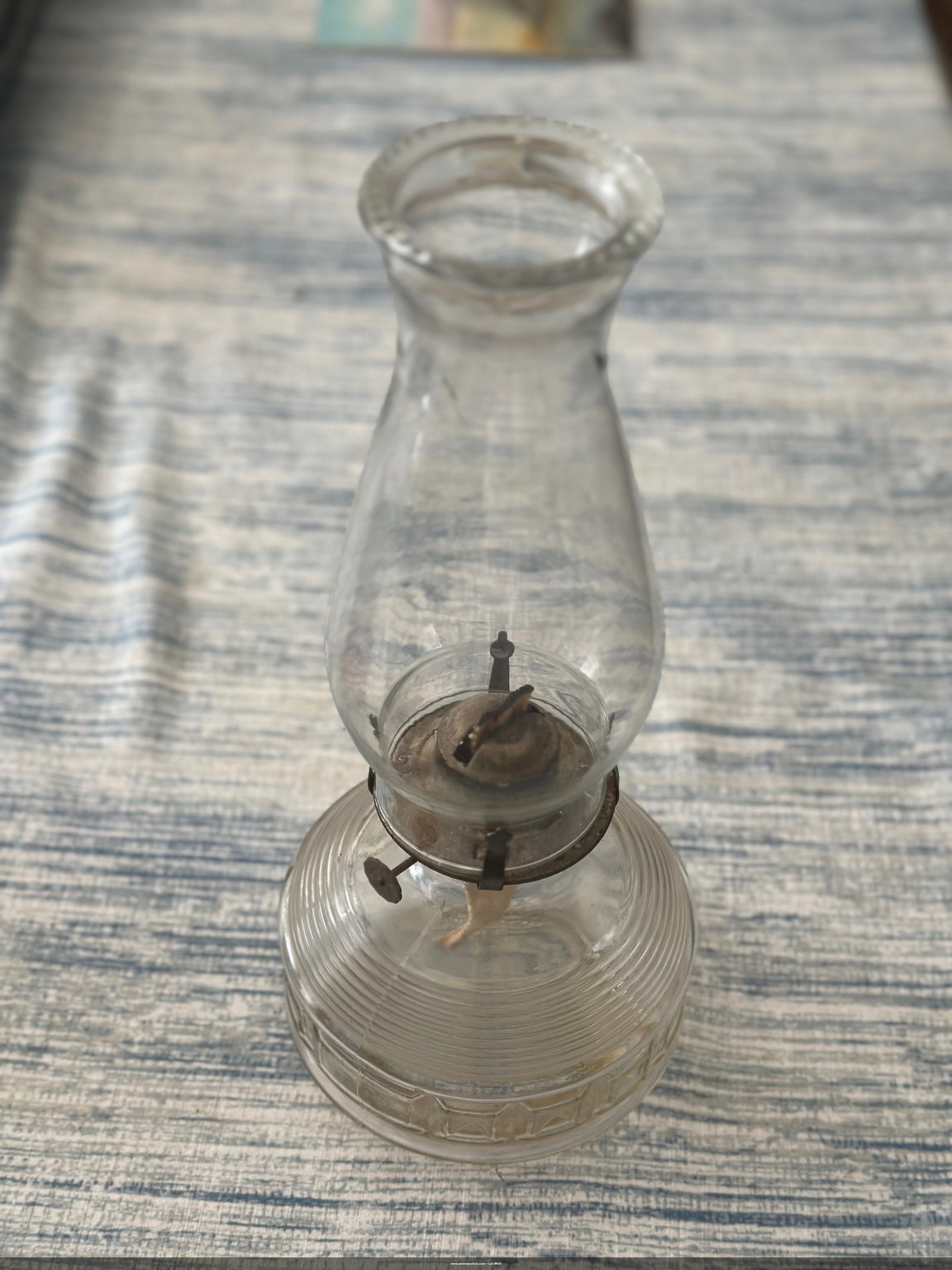 Vintage Glass Oil Lamp: This elegant vintage glass oil lamp features a classic design with a ribbed base and brass fittings. Perfect for collectors or as a decorative piece, it captures the charm of bygone eras