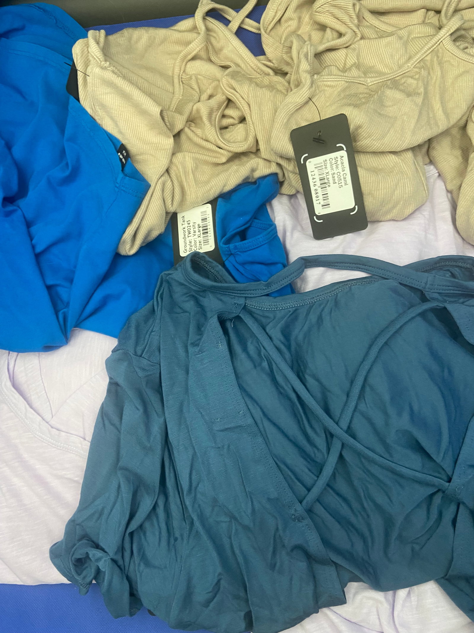 Brand New with tags Activewear: Assortment of XL brand new with tags NUX Activewear Tank tops sleeveless and cap sleeves. Variety of colors, lilac, blues, Sand. Lot of 11 High Estimate: 500.00