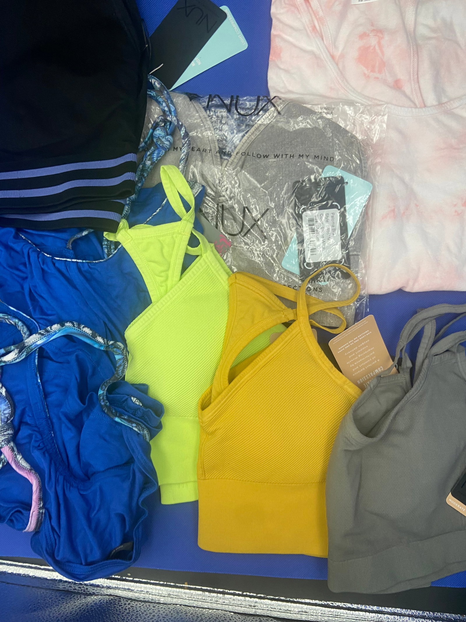 Activewear brand new: A variety of brand new with tags NUX activewear tops in a assortment of colors and styles. All sizes are medium. Lot of 8 High Estimate: 500.00