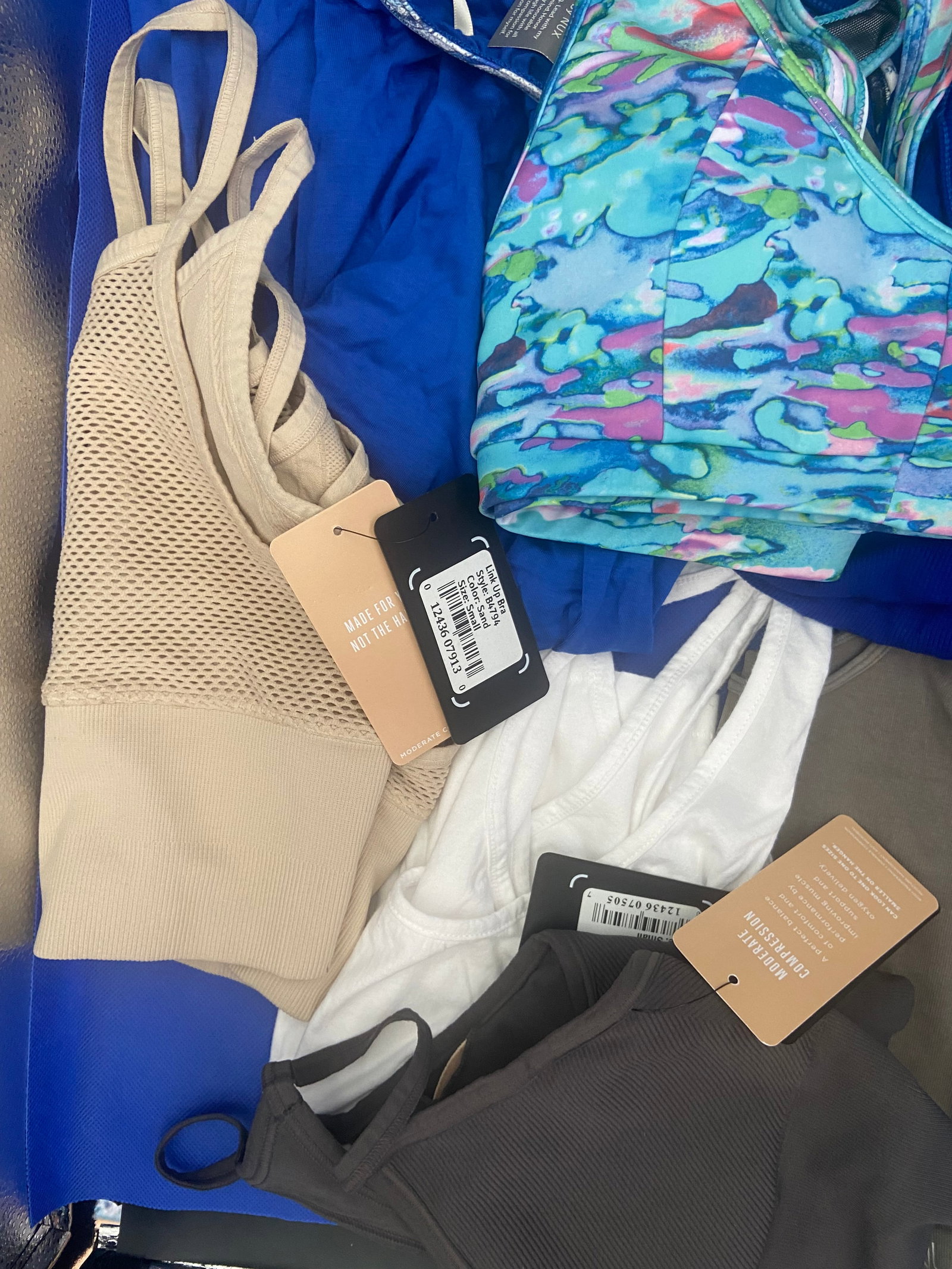 Brand New with tags Activewear: A variety of brand new with tags NUX activewear tops in an assortment of colors and styles. All sizes are small. Lot of 15 High Estimate: 500.00