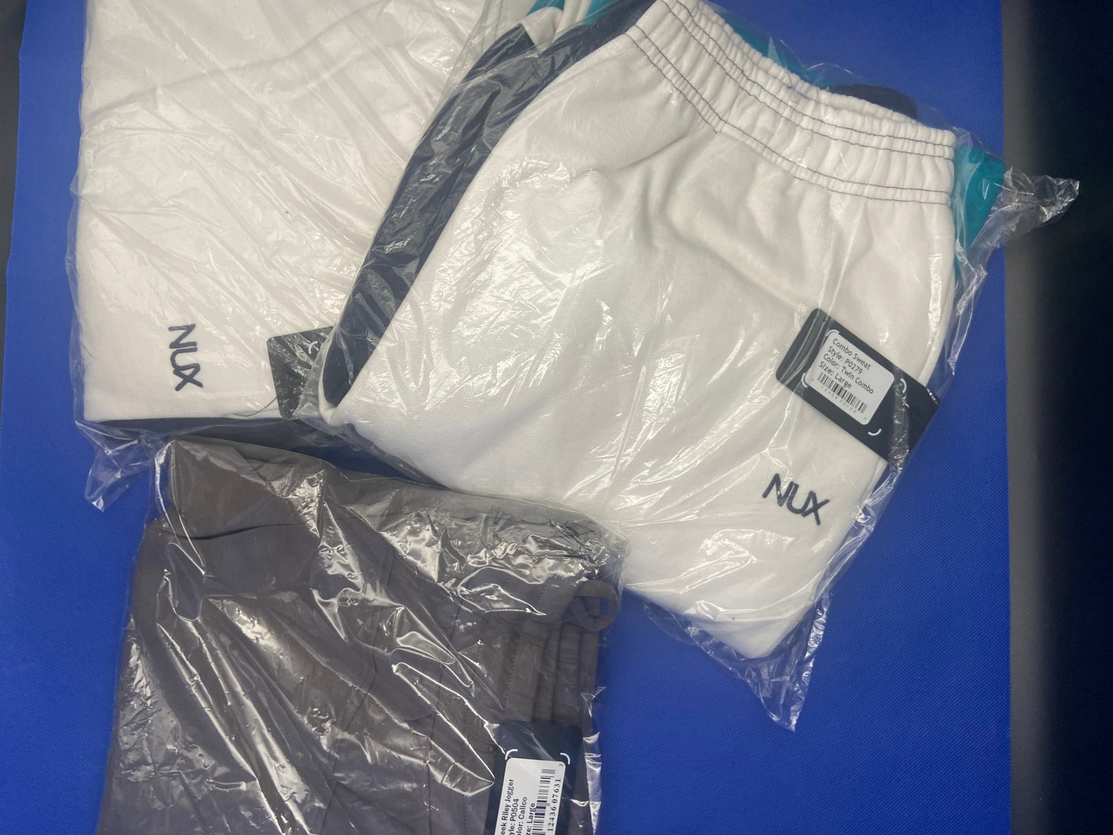 Streetwear brand new: Brand New with tags NUX streetwear bottoms. All sizes are large. Styles are Sleek Riley Jogger and Combo Sweat. High Estimate: 500.00