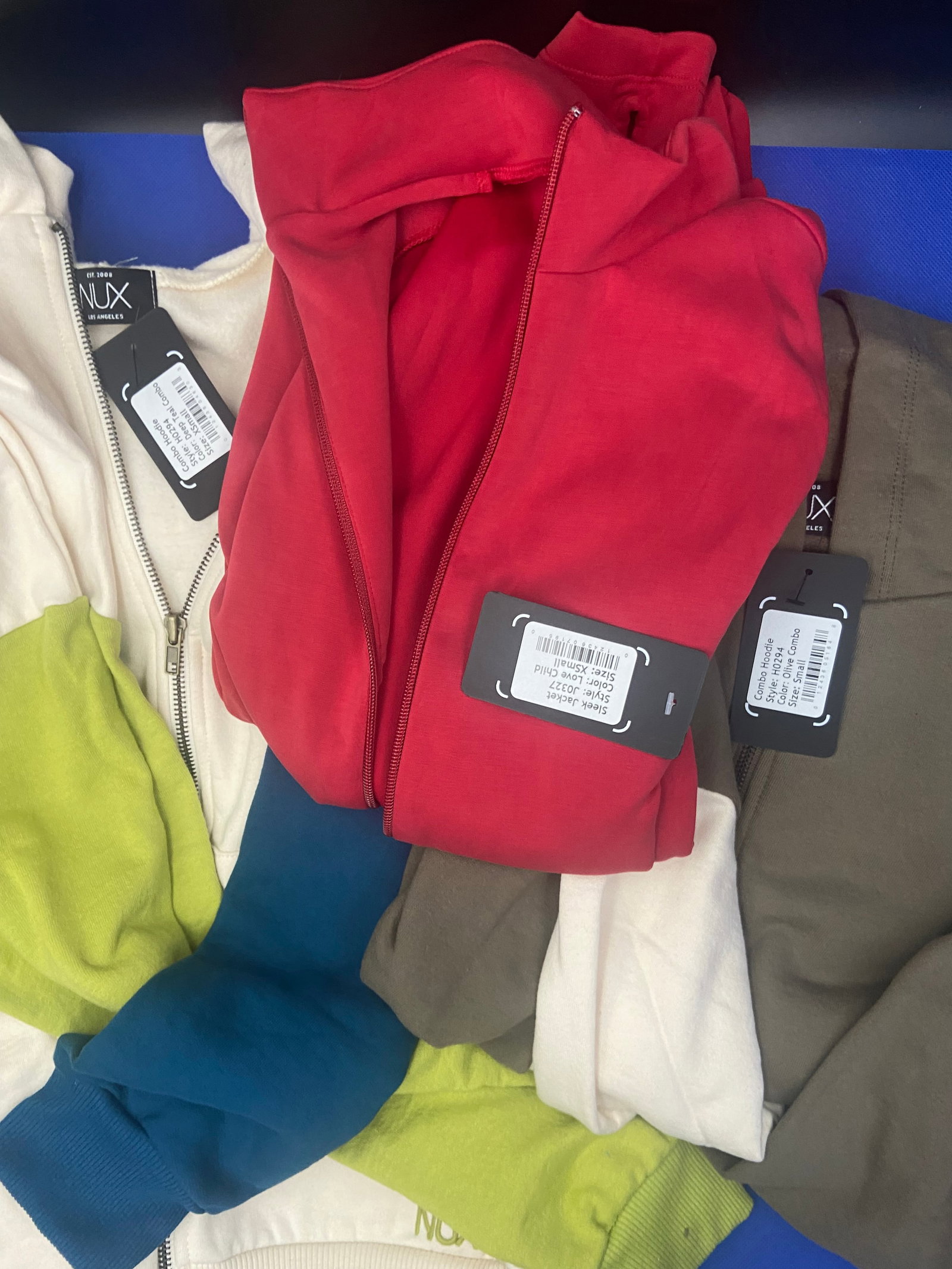 Streetwear brand new: Brand New with tags NUX streetwear tops. Two are size x-small Combo hoodie, Sleek jacket in red. One is size small combo hoodie. Lot of 3 tops High Estimate: 500.00