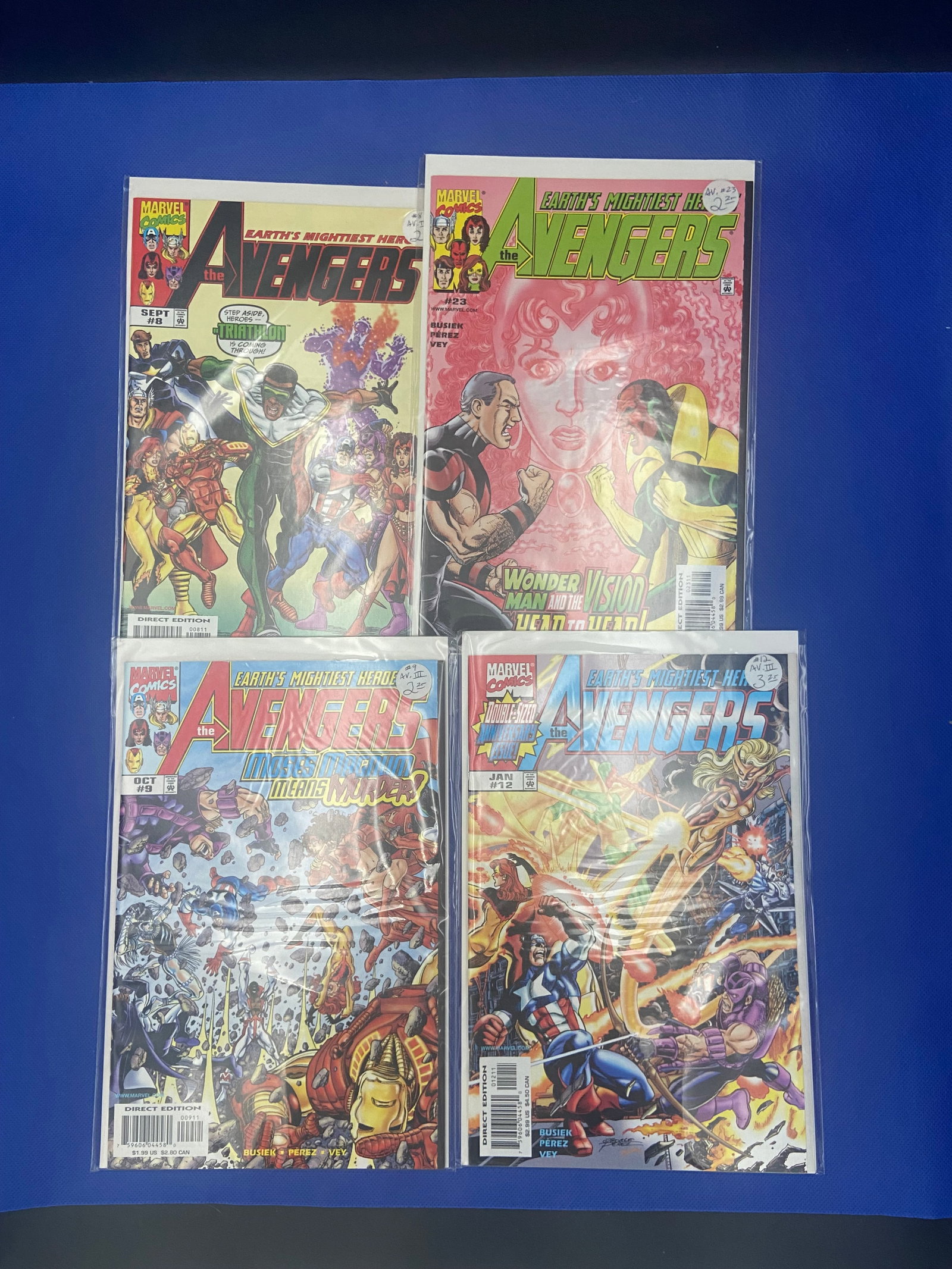 Avengers Comics - Lot of 4: four Marvel 'Avengers' comic books from varying series, showcasing iconic characters such as Iron Man and Scarlet Witch. Notable issues include classic artwork and storylines, appealing to both