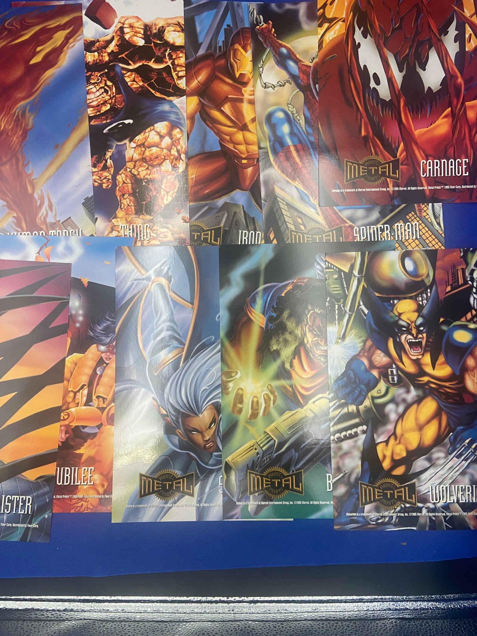 Marvel Metal Trading Cards - Lot Of 10: Marvel Metal trading cards showcasing iconic characters such as Wolverine, Spider-Man, and Carnage. The cards highlight vibrant artwork and are likely part of a series known for its unique metal finis