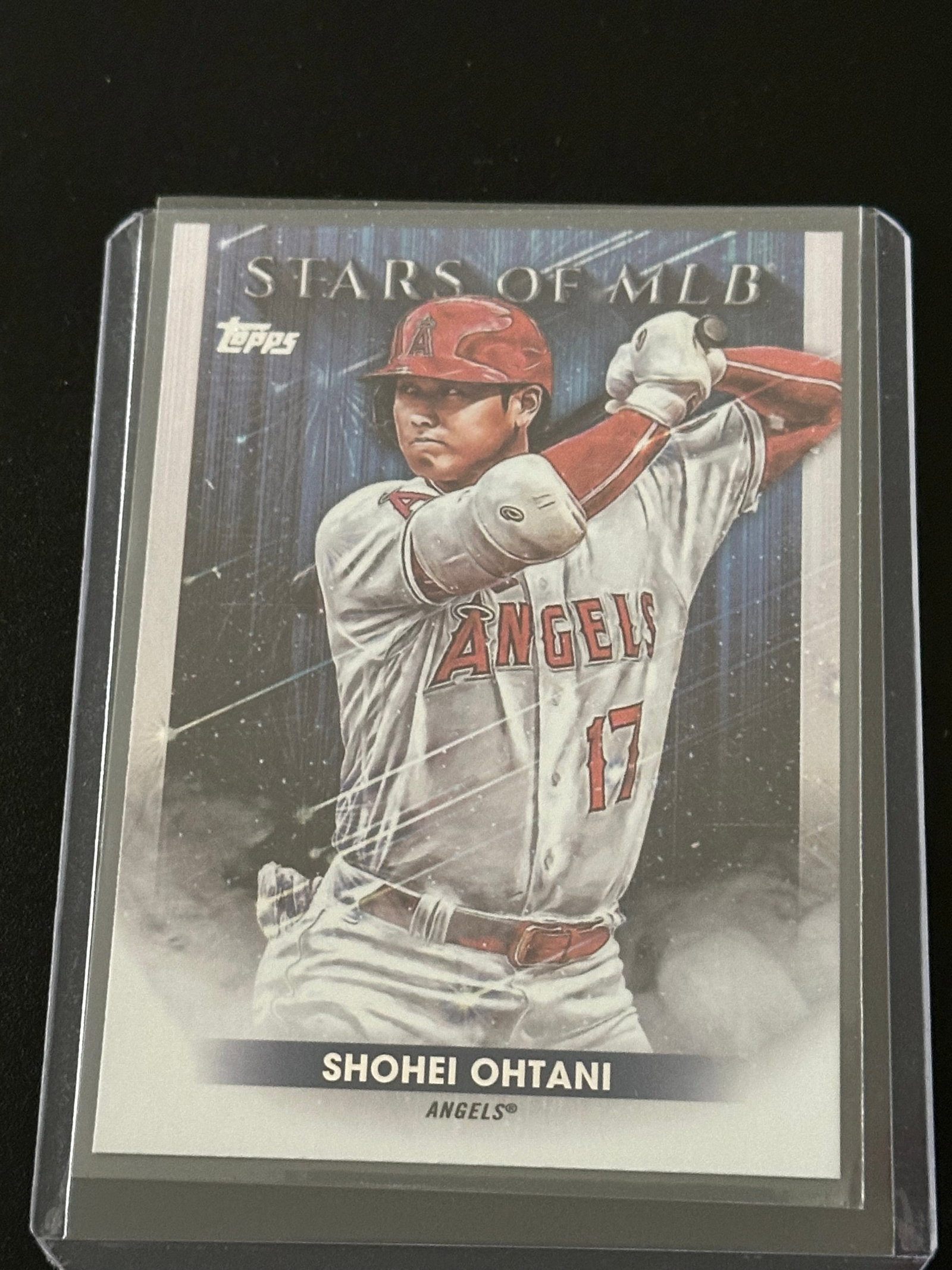 2022 Topps Stars of MLB Shohei Ohtani #SMLB-24: 2022 Topps Stars of MLB Shohei Ohtani #SMLB-24 baseball card encased in a protective plastic holder.Player: Shohei Ohtani (Los Angeles Angels).Card Set: 2022 Topps Series 1 - Stars of MLB.Card Type: I