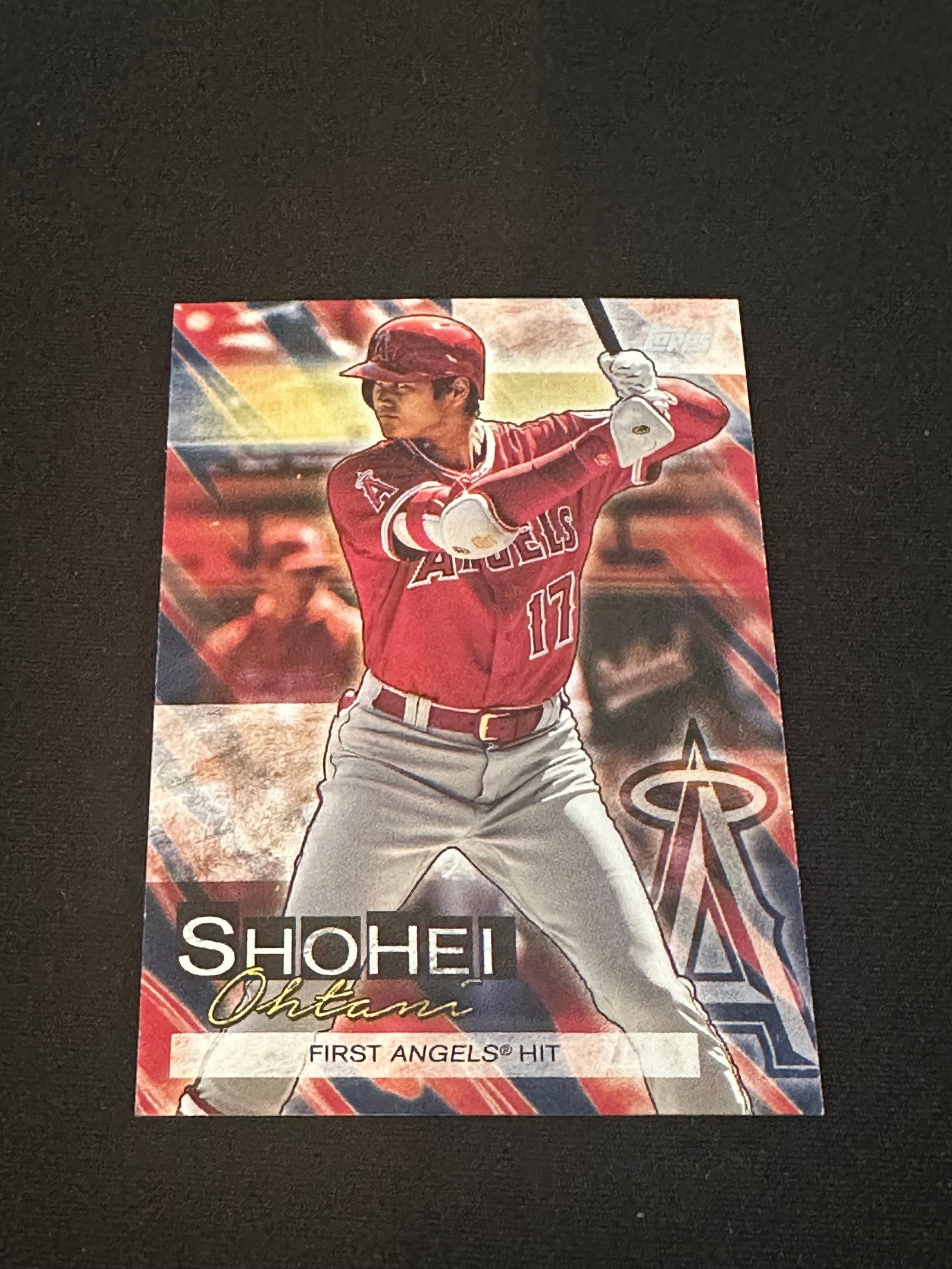 ROOKIE CARD -2018 Topps Shohei Ohtani First Angels Hit Card: This is a 2018 Topps baseball card featuring Shohei Ohtani in his Los Angeles Angels uniform. The card commemorates his 'First Angels Hit' with the team. It is a standard trading card from the 2018