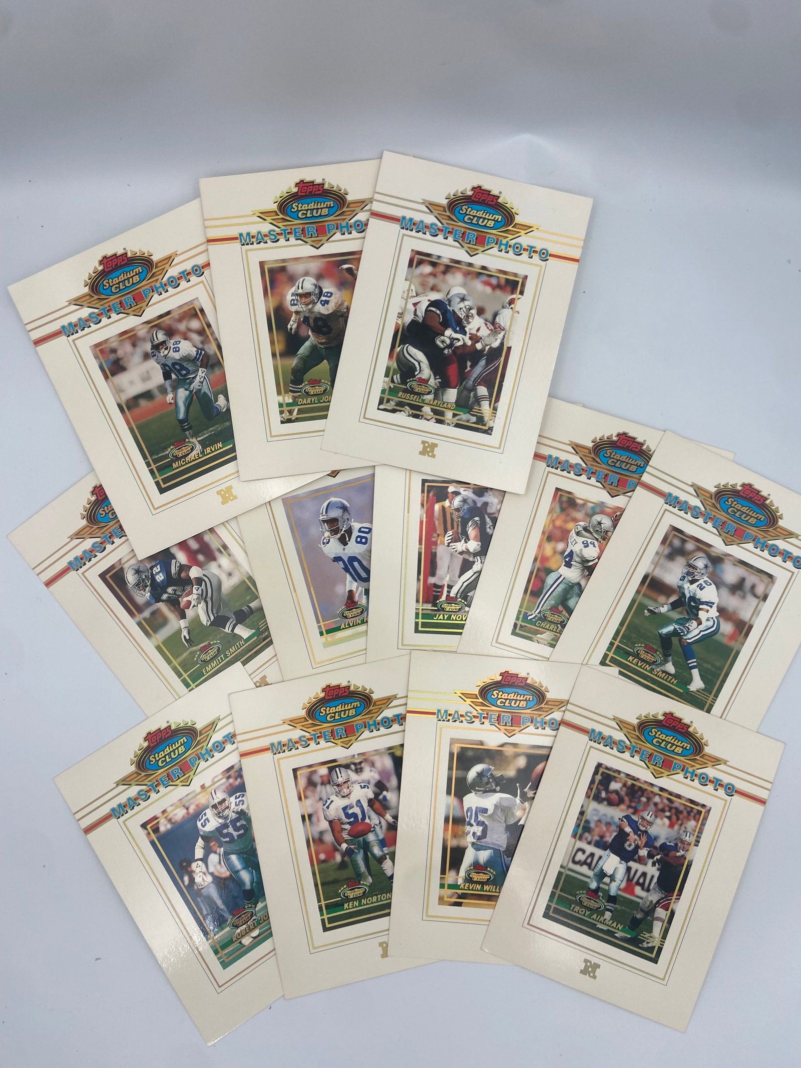 1994 Topps Stadium Club Master Photo Collection: Collection of 1994 topps stadium club master photo insert cards featuring various dallas cowboys players. These oversized collector photos highlight notable athletes from the team in a distinctive