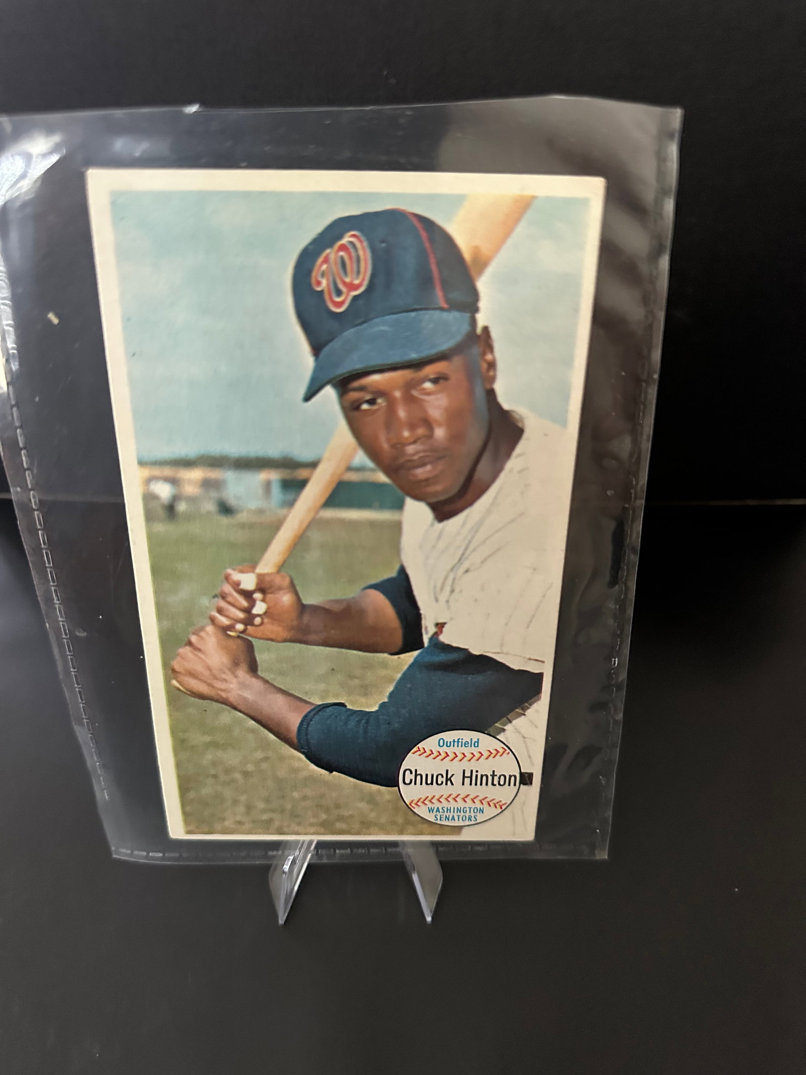 1964 Topps Giant Chuck Hinton Baseball Card: 1964 topps baseball card featuring chuck hinton, an outfielder for the washington senators. The card displays a portrait of hinton holding a bat and highlights his official team logo. It is in good