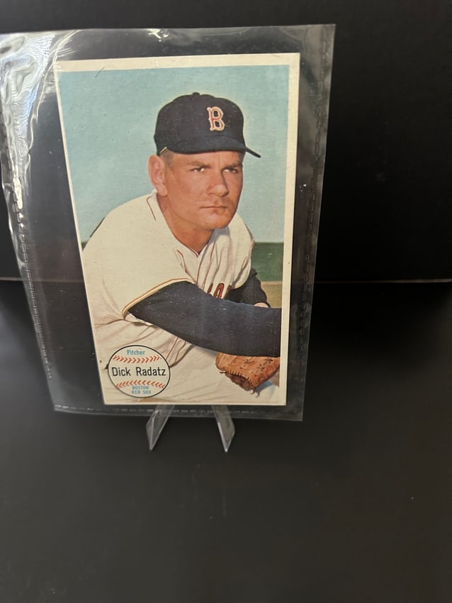 1964 Topps Giants Dick Radatz Boston Red Sox Baseball Card: This is a 1964 topps baseball card featuring dick radatz, a pitcher who played for the boston red sox. The card displays a classic image of radatz in his team uniform along with his name and player