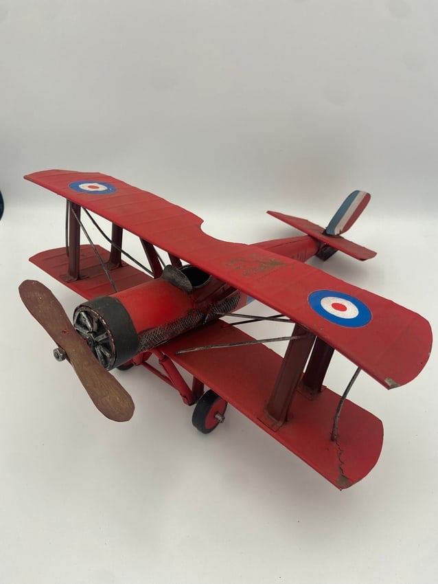 Vintage Tin Plate Biplane: Red baron tri-plane model airplane is a vintage collectible featuring a wwi propeller design, made of tin metal in a unique tri-plane configuration.