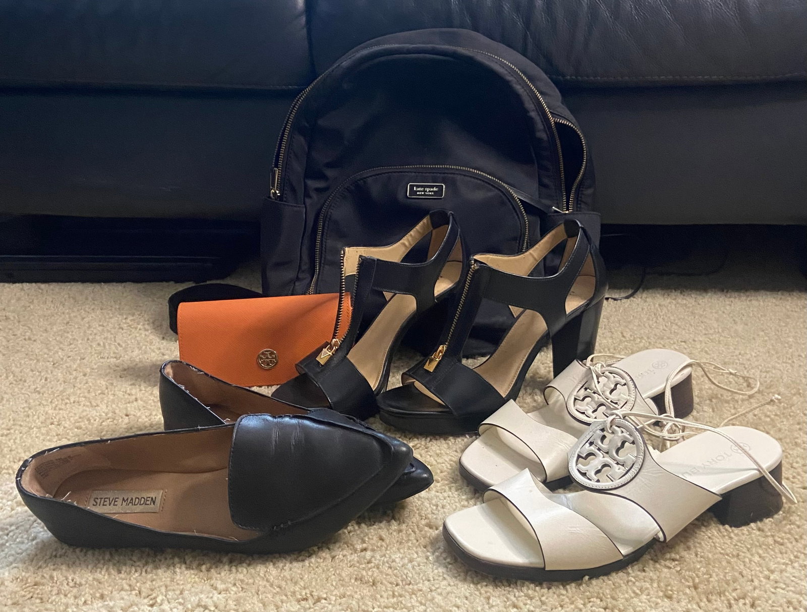 Mixed Designer Accessories And Shoe Lot: Lot features a variety of designer fashion accessories, including a black kate spade backpack, a tory burch sunglass case and sandals, a pair of steve madden loafers, and michael kors heel and black b