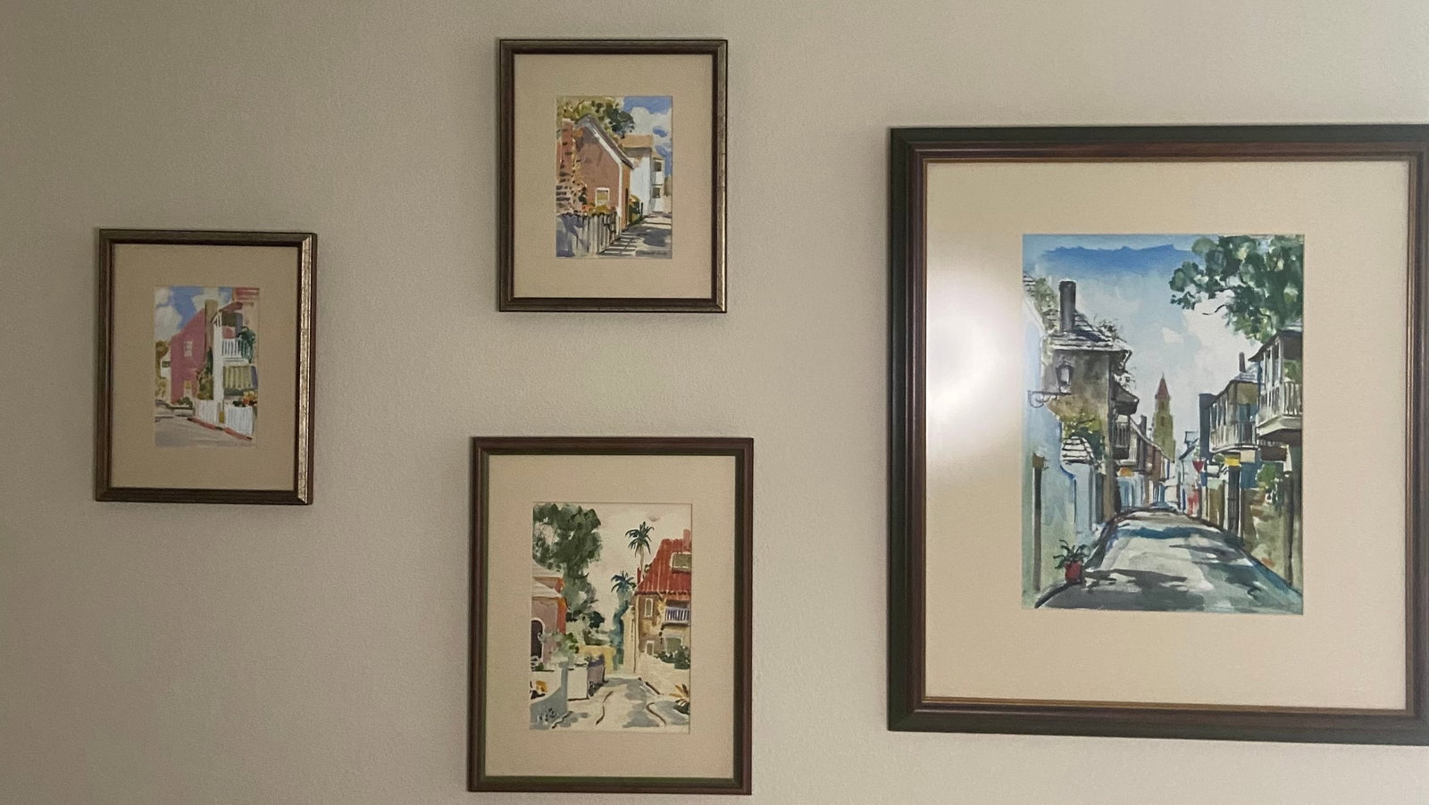 Emmett Fritz Watercolor House Paintings: An original watercolor paintings by the noted artist emmett fritz. The artwork depicts a house scene with a pink facade and white fence, professionally matted and framed in a dark wood frame - Sold