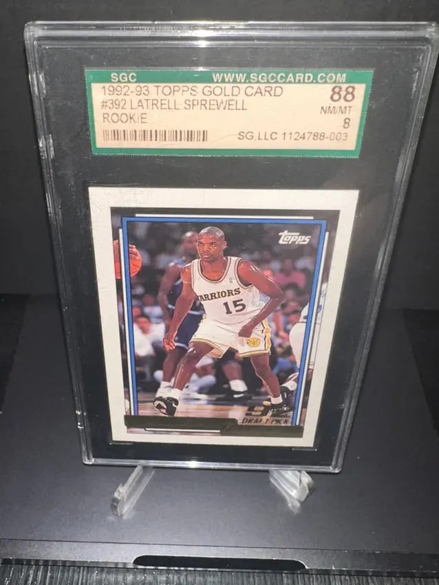 1992-93 Topps Latrell Sprewell Rookie Card: 1992-93 topps latrell sprewell rookie card, numbered #392. It is graded 8 (nm/mt) by sgc, indicating its near mint condition. This card features the player in action, showcasing his time with the